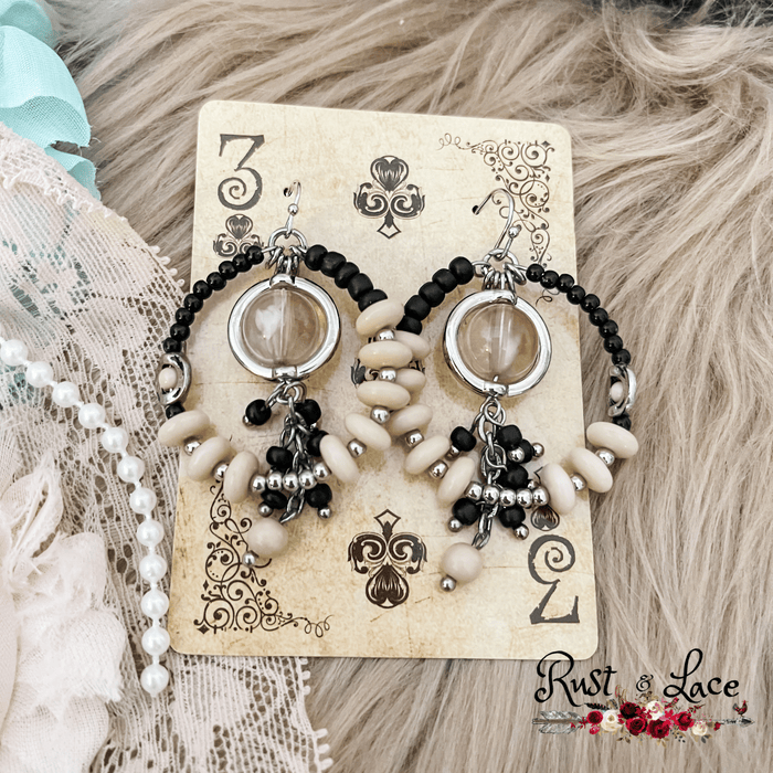Black and ivory circle shaped earrings with a beaded center